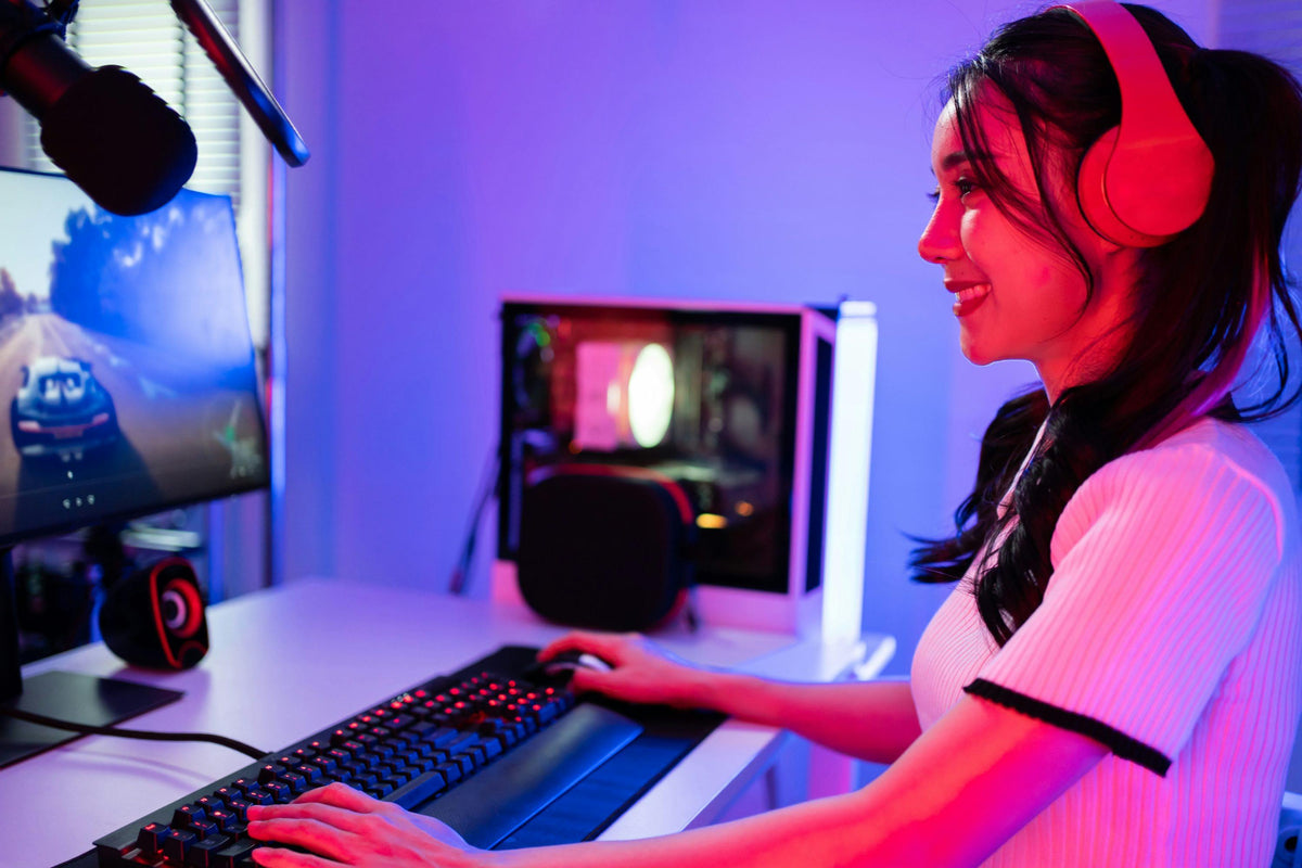 Content creator working at a modern workspace with dual monitors, headphones and professional desk setup.